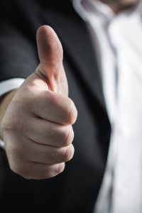 pexels-photo-327533-327533 A close-up of a man's thumbs up gesture, symbolizing success and agreement.